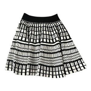 Forever 21 black and white circle patterned acrylic mini skirt.